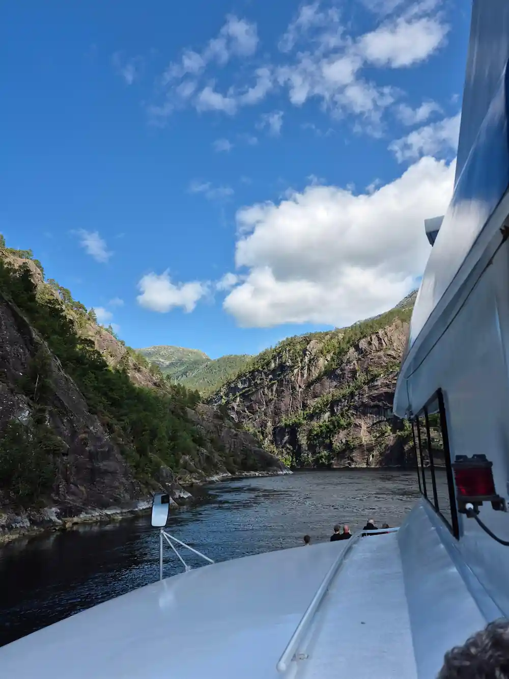 The bow and superstructure with the fjord narrowing ahead