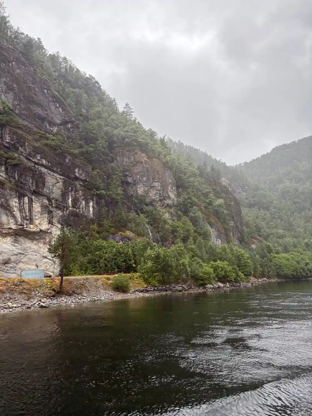A quiet fjord reach with grey cliffs on both sides