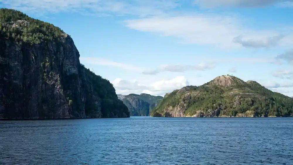 Steep dark cliffs closing in on the fjord channel