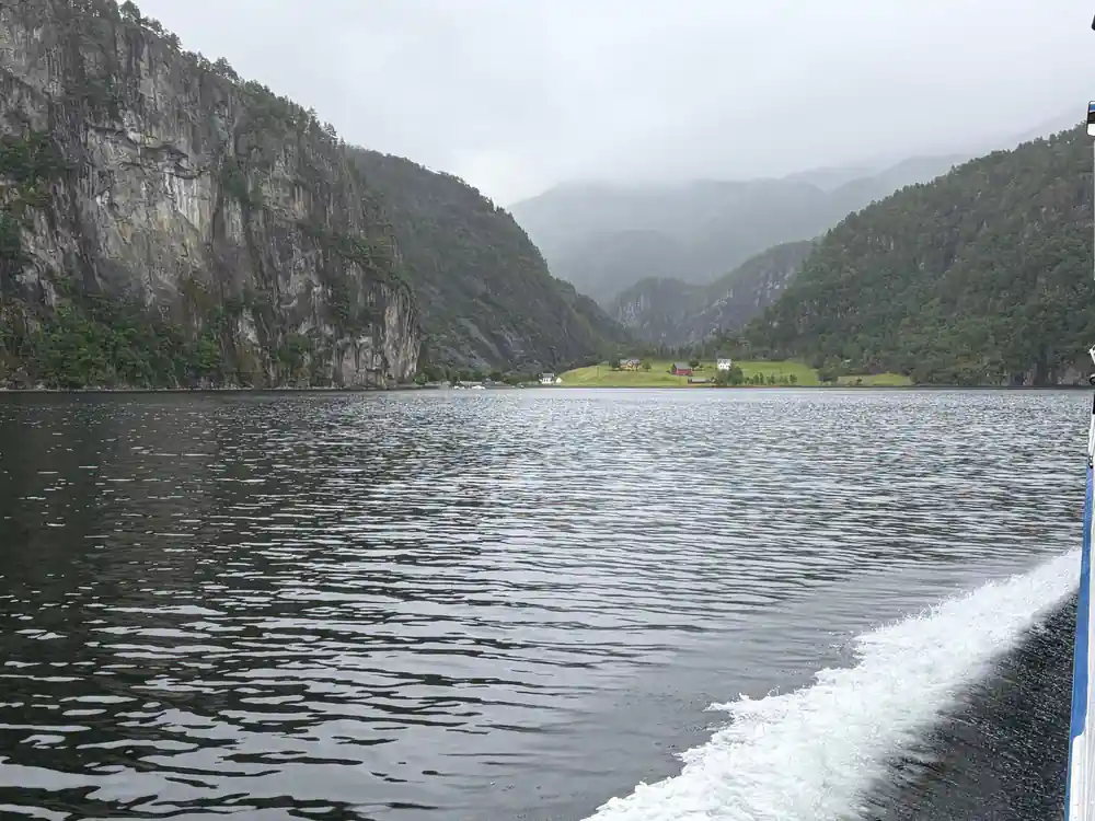 A valley opening at the head of the fjord under cloud