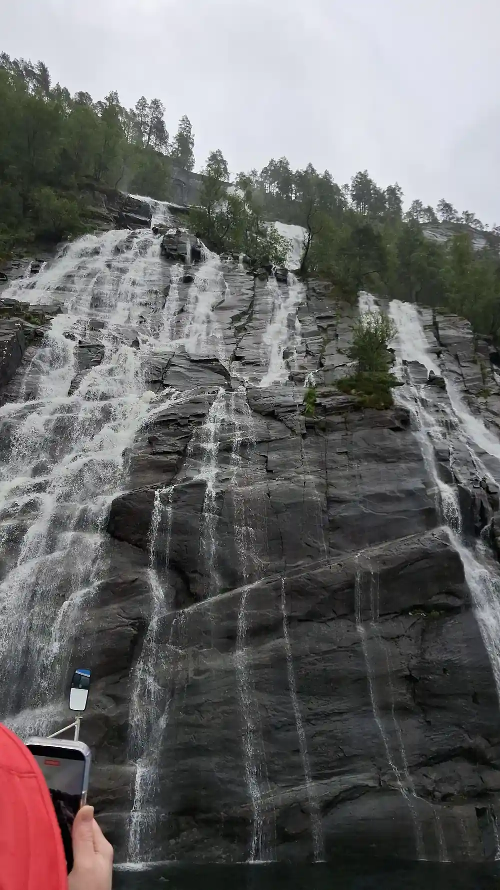 Water streaking a wide banded rock face